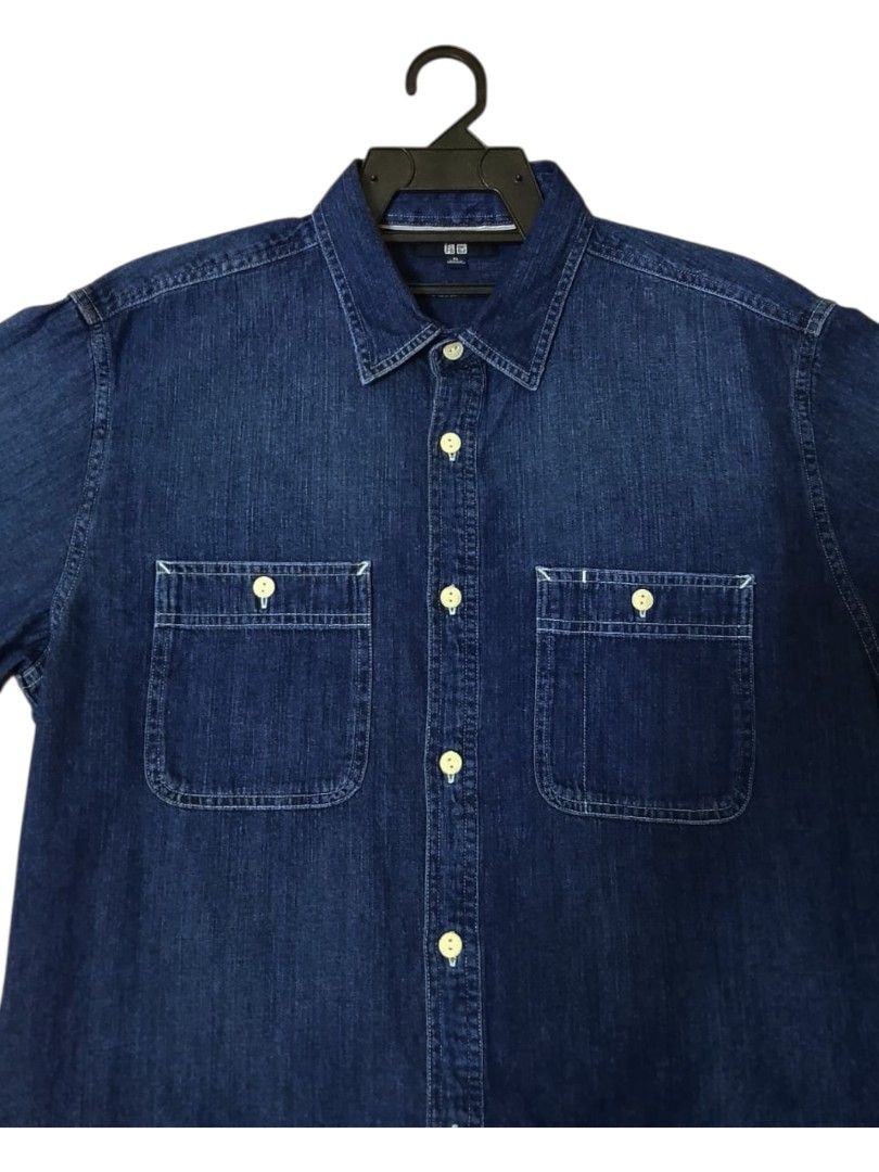 Uniqlo Denim Shirt XL (Category: Formal Shirts) located in Lunas. Submitted by znz_collections (Listing ID 1430604467, Image 2). Description: Uniqlo denim shirt in size XL. Features a classic button-down design with two chest pockets. The shirt is a dark blue denim color. Made in Bangladesh. The shirt has long sleeves and a standard collar. The tag indicates the shirt is a size XL. Size XL Pit to Pit : 24 inches Length : 30 inches.