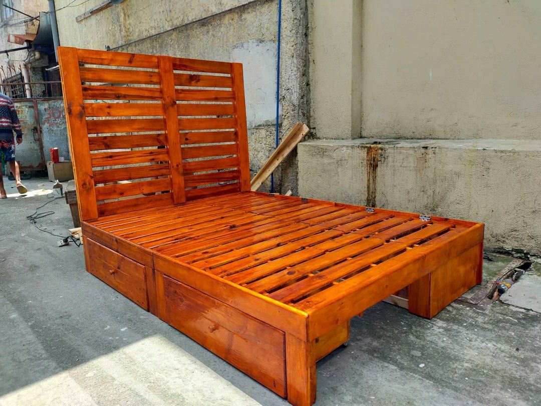 Wooden Bed Frame with Storage (Category: Bed Frames & Mattresses) located in Santa Rosa. Submitted by endlessriaa (Listing ID 1430643877, Image 2). Description: Full Double Palochina Bed Size: 54*75” 12” floor to bed with 2 secret storage 2 drawers with space on planks sa papag 42” from bed headboard collapsible with lock walnut varnished 📍 Santa Rosa, Laguna *Self booking of Lalamove or other transport services..