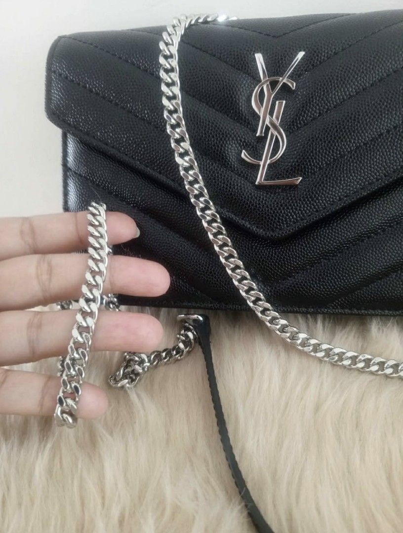 YSL Wallet on Chain Bag (Category: Luxury Bags & Wallets) located in Manila. Submitted by lanyklein (Listing ID 1430733417, Image 3). Description: Black YSL wallet on chain bag with silver-tone hardware. Features a chevron-quilted design and a chain strap. The interior includes multiple card slots and a zippered compartment. The bag is compact and suitable for carrying essentials. The YSL logo is prominently displayed on the front..
