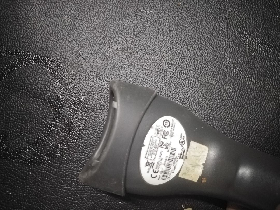 Zebra LS1203 Barcode Scanner (Category: Printers, Scanners & Copiers) located in Manila. Submitted by maybonifacio (Listing ID 1430694448, Image 2). Description: Zebra LS1203 barcode scanner. It has a USB connector and a long cable. The scanner has a yellow button and a gray body. The model number LS1203 is visible on the product label..
