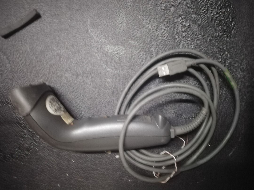 Zebra LS1203 Barcode Scanner (Category: Printers, Scanners & Copiers) located in Manila. Submitted by maybonifacio (Listing ID 1430694448, Image 1). Description: Zebra LS1203 barcode scanner. It has a USB connector and a long cable. The scanner has a yellow button and a gray body. The model number LS1203 is visible on the product label..