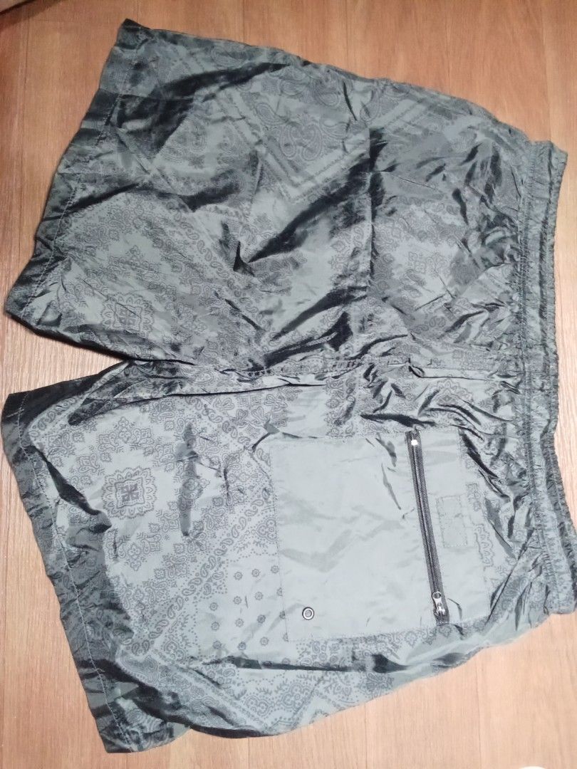 2XL Paisley Print Shorts (Category: Shorts) located in Makati City. Submitted by kuysman (Listing ID 1430835143, Image 2). Description: These shorts feature a paisley print design. They have a drawstring closure and a back pocket with a zipper. The size is 2XL. The shorts are a dark color, possibly gray or black. They appear to be made of a lightweight material. only sensible questions are entertained fits large stretchable 1 left .