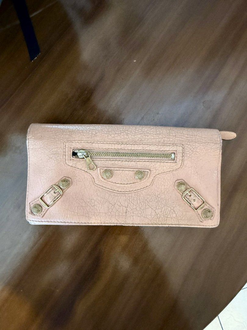 Balenciaga Classic Continental Wallet (Category: Luxury Bags & Wallets) located in Paranaque City. Submitted by gabprelovedstuff (Listing ID 1430821719, Image 1). Description: - Balenciaga Classic Continental Wallet - Blush pink color - Features textured leather - Signature hardware details - Spacious interior - Can put chain - Pre-loved condition - Tarnishing in hardware - Has rubs - Can be brought to bag spa but also ready to with its vintage l