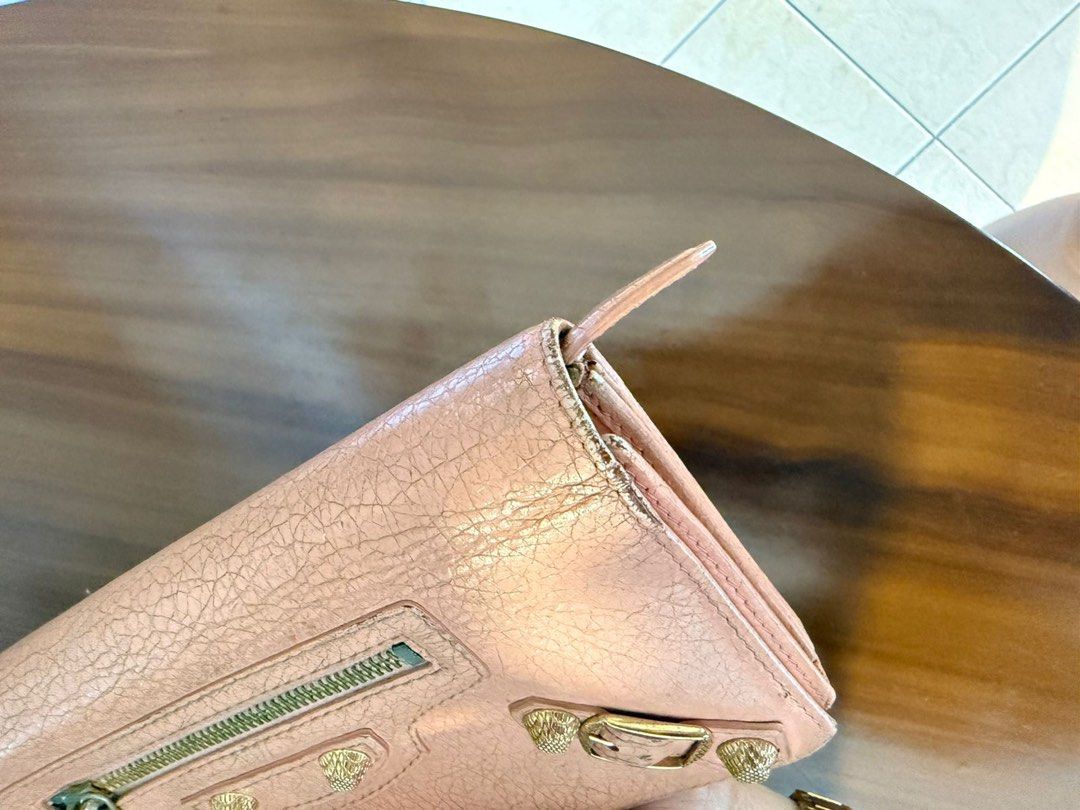 Balenciaga Classic Continental Wallet (Category: Luxury Bags & Wallets) located in Paranaque City. Submitted by gabprelovedstuff (Listing ID 1430821719, Image 2). Description: - Balenciaga Classic Continental Wallet - Blush pink color - Features textured leather - Signature hardware details - Spacious interior - Can put chain - Pre-loved condition - Tarnishing in hardware - Has rubs - Can be brought to bag spa but also ready to with its vintage l