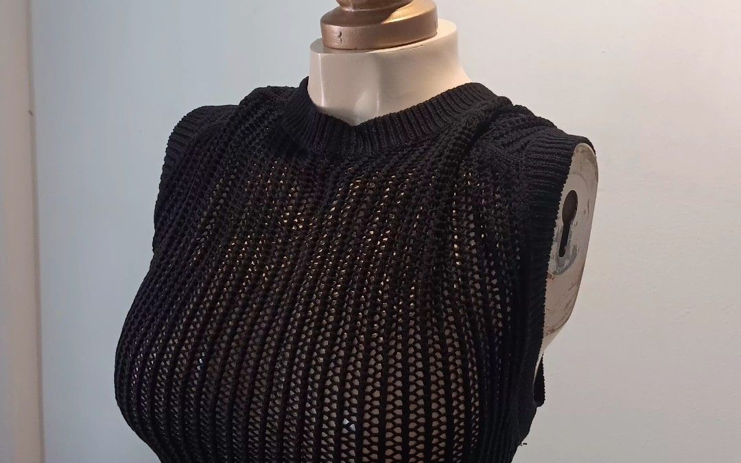 Black Knit Top (Category: Sleeveless) located in Manila. Submitted by sonummy (Listing ID 1430908553, Image 3). Description: Black knit top features a unique design. It has a cropped length and a textured knit pattern. The top is sleeveless and has a high neckline. It is a versatile piece that can be dressed up or down..
