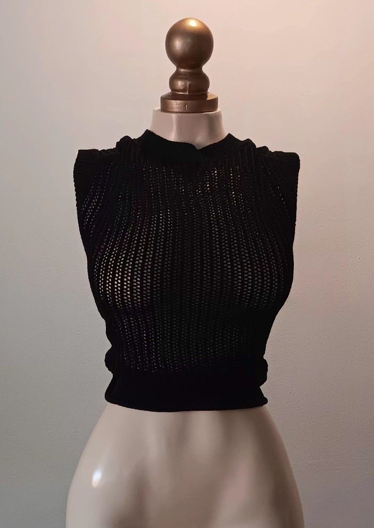 Black Knit Top (Category: Sleeveless) located in Manila. Submitted by sonummy (Listing ID 1430908553, Image 1). Description: Black knit top features a unique design. It has a cropped length and a textured knit pattern. The top is sleeveless and has a high neckline. It is a versatile piece that can be dressed up or down..