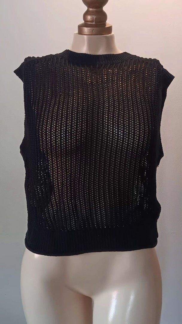 Black Knit Top (Category: Sleeveless) located in Manila. Submitted by sonummy (Listing ID 1430908553, Image 2). Description: Black knit top features a unique design. It has a cropped length and a textured knit pattern. The top is sleeveless and has a high neckline. It is a versatile piece that can be dressed up or down..