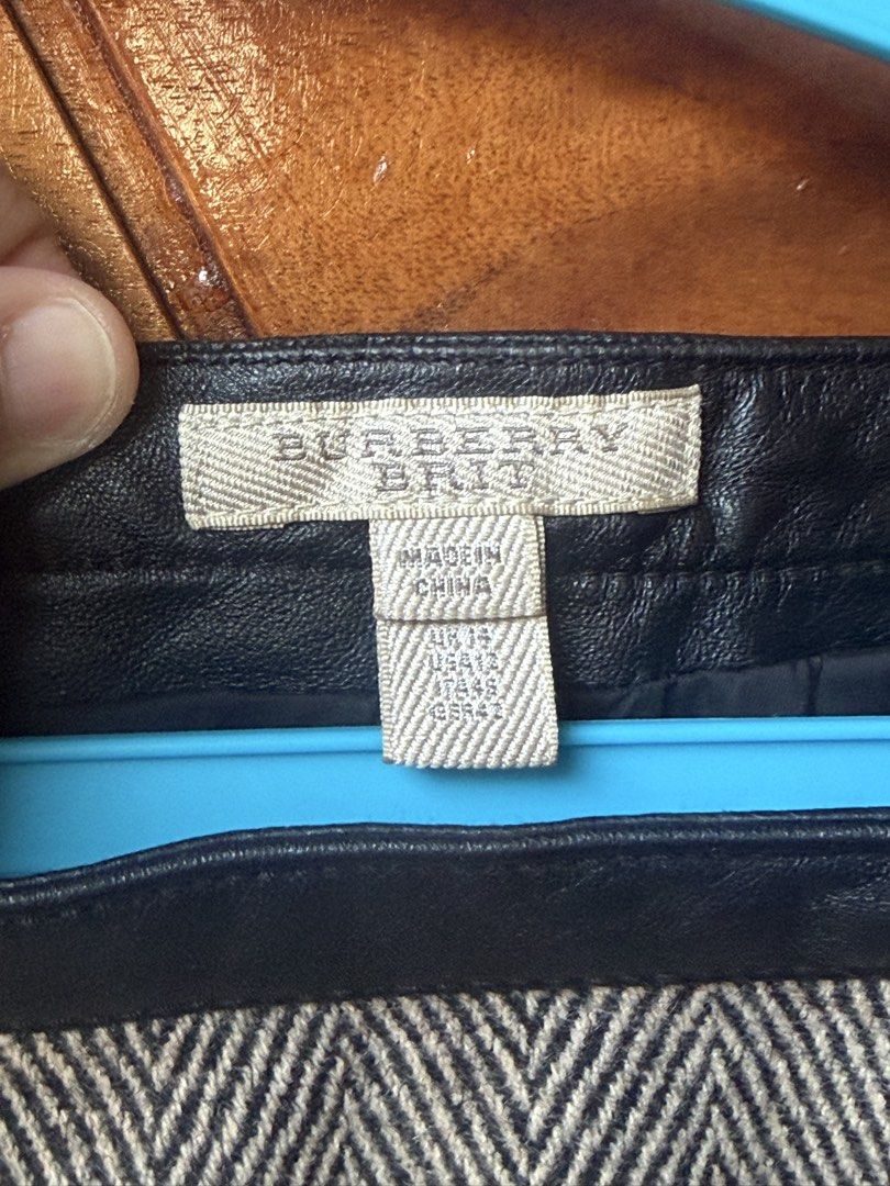 Burberry Brit Herringbone Skirt (Category: Skirts) located in Cavite. Submitted by peppermintsss (Listing ID 1430978530, Image 3). Description: • Stylish Burberry Brit skirt. •Features a herringbone pattern with leather detailing. •T zippered pockets. •Size on tag: UK 12, USA 12, IT 44, GER 40. •The skirt has a black leather waistband and a black lining. •Fabric composition is 47% wool, 27% polyester, and 26% viscose. WAIST: 30” LENGHT: 22”.