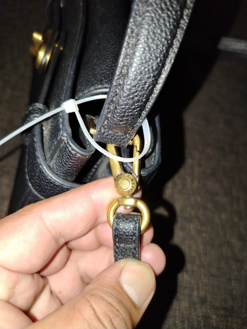 Charles & Keith Black Handbag (Category: Luxury Bags & Wallets) located in Munoz. Submitted by makie_ukay (Listing ID 1430936184, Image 3). Description: Black handbag from Charles & Keith. Features a top handle and a detachable shoulder strap. The bag has a rectangular shape with a gold-tone clasp closure. The brand name is visible on the front and inside the bag. Includes a zipper pocket inside..
