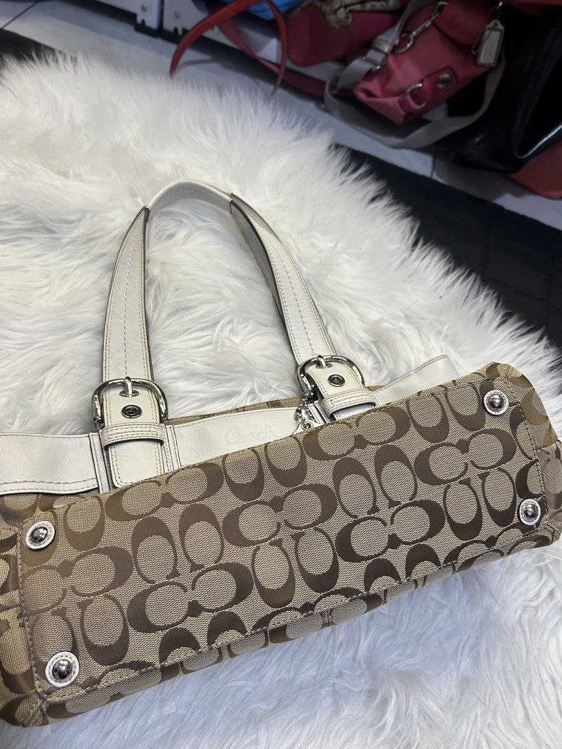 Coach Signature Tote Bag (Category: Luxury Bags & Wallets) located in Manila. Submitted by graceyabut0 (Listing ID 1430890422, Image 3). Description: - Authentic Coach tote bag - Signature brown and tan monogram pattern - White leather accents - Dual top handles - Silver-tone hardware - Coach hangtag included - Zip closure - Multiple interior compartments.