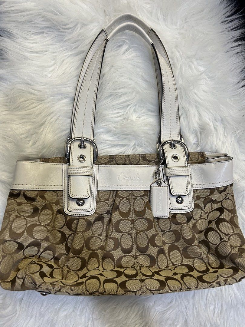 Coach Signature Tote Bag (Category: Luxury Bags & Wallets) located in Manila. Submitted by graceyabut0 (Listing ID 1430890422, Image 1). Description: - Authentic Coach tote bag - Signature brown and tan monogram pattern - White leather accents - Dual top handles - Silver-tone hardware - Coach hangtag included - Zip closure - Multiple interior compartments.
