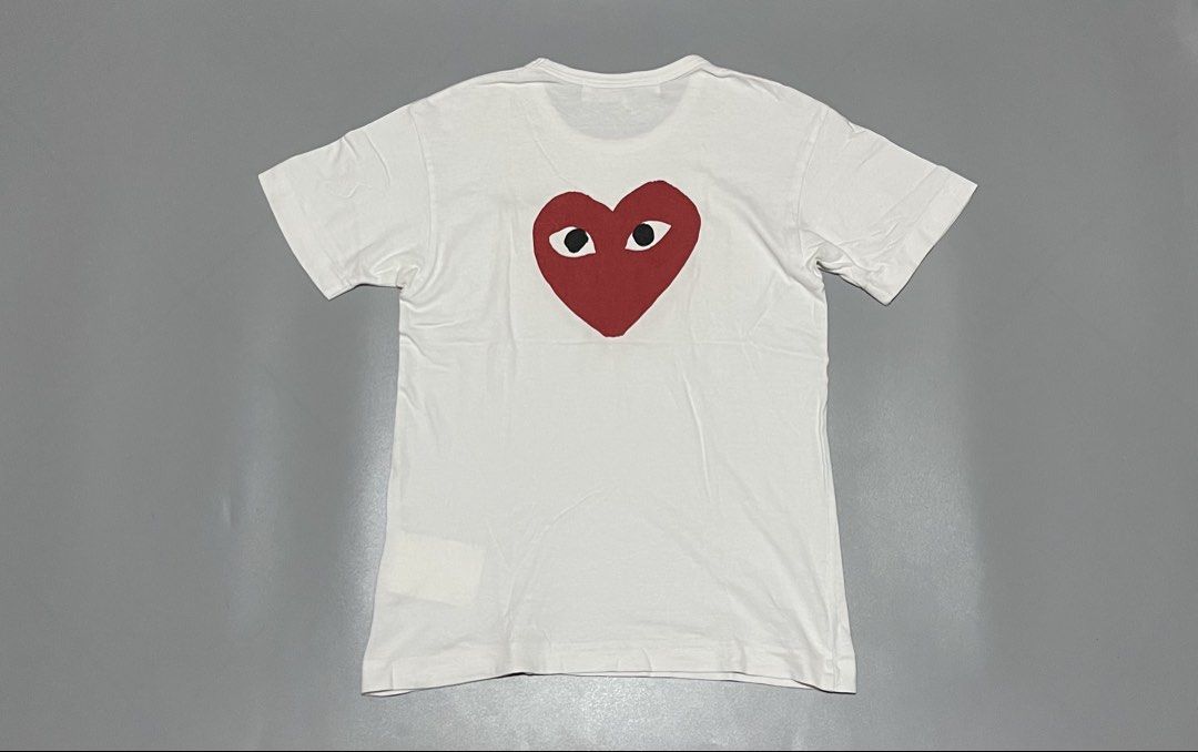 Comme des Garcons Red Emblem Mirror Tee (Category: Tshirts & Polo Shirts ) located in Angeles City. Submitted by andreiboughts (Listing ID 1430812904, Image 2). Description: Length: 25 Width: 17 Condition: 9.8/10 Color rate: 9.8/10 Issue (s): None Complete Tags ✅ Small on tag.