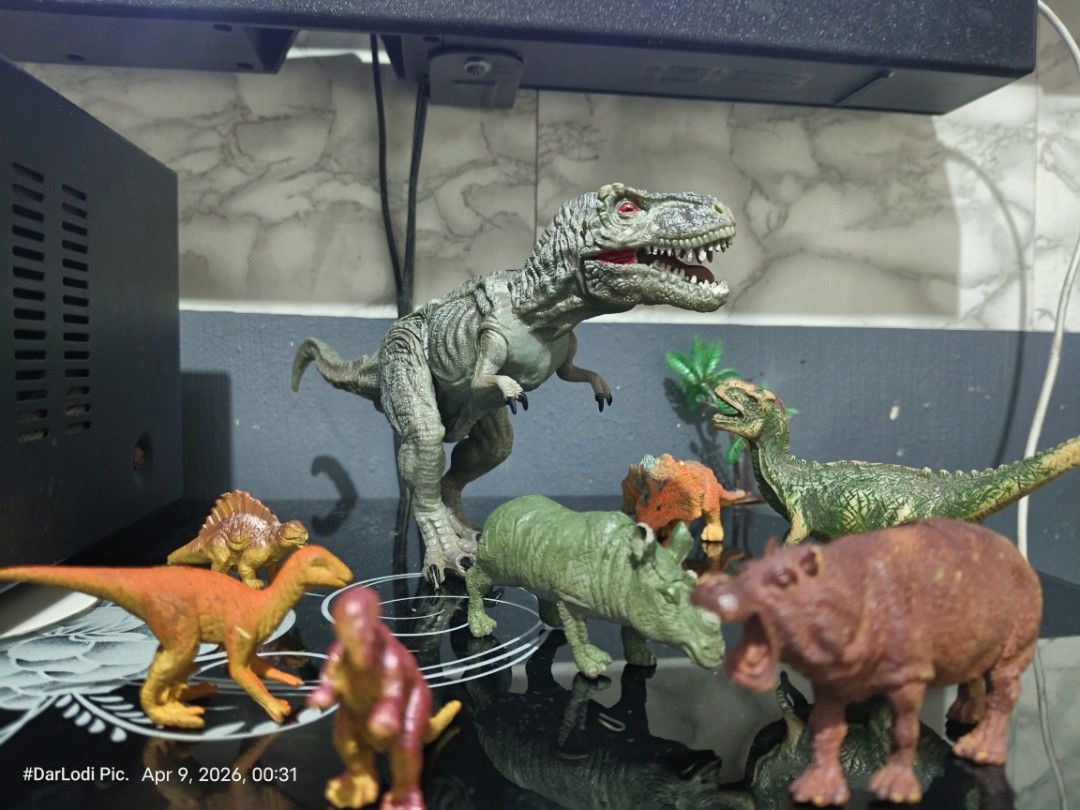 Dinosaur Toy Figures Set ( Take all) (Category: Action & Battle Toys) located in Pasay City. Submitted by mancave07 (Listing ID 1430962896, Image 2). Description: Set of dinosaur toy figures, including a T-Rex, Triceratops, and other prehistoric creatures. The T-Rex has red eyes and a detailed design. Made in China. Includes a zebra and a hippo figure. Great for kids or collectors at Bawal sa maselan..