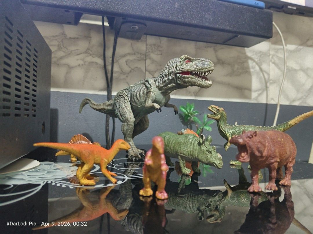 Dinosaur Toy Figures Set ( Take all) (Category: Action & Battle Toys) located in Pasay City. Submitted by mancave07 (Listing ID 1430962896, Image 3). Description: Set of dinosaur toy figures, including a T-Rex, Triceratops, and other prehistoric creatures. The T-Rex has red eyes and a detailed design. Made in China. Includes a zebra and a hippo figure. Great for kids or collectors at Bawal sa maselan..