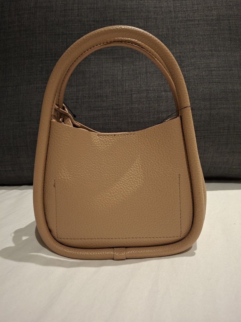 DKNY Capri Hobo Crossbody Bag (Category: Cross-body Bags) located in Makati City. Submitted by jacky222323 (Listing ID 1430924570, Image 2). Description: From US Bnew - DKNY Capri Hobo crossbody bag - Tan color - Top handle and detachable shoulder strap - Main compartment with zippered pouch - DKNY logo on front - Original price tag attached: $138 MSRP.