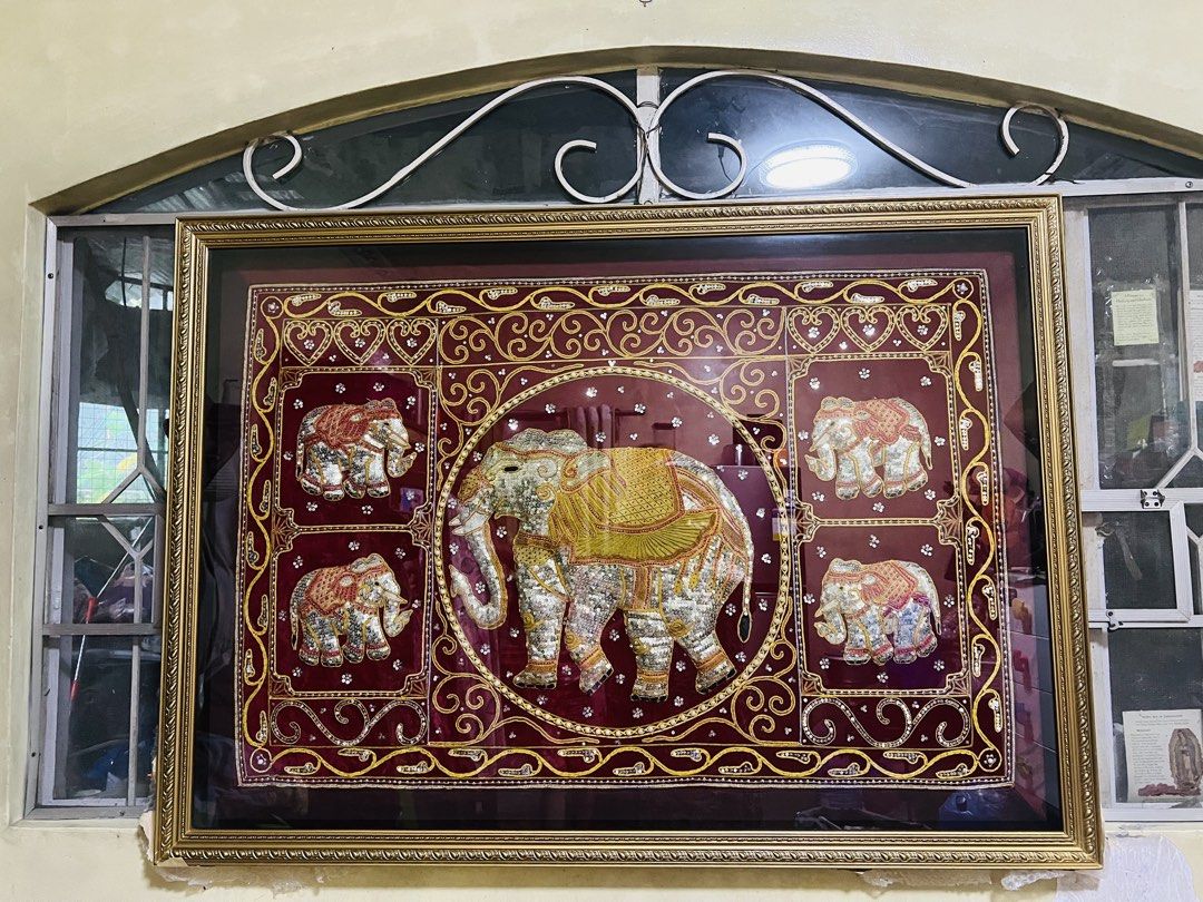 Elephant Wall Art with Frame (Category: Frames & Pictures) located in Antipolo. Submitted by murapod2 (Listing ID 1430887574, Image 1). Description: Beautiful framed wall art featuring an elephant design. The artwork is set against a maroon background with intricate gold detailing. The frame is gold-colored, adding to the elegance of the piece. The art is protected by glass. 4X6 ft.