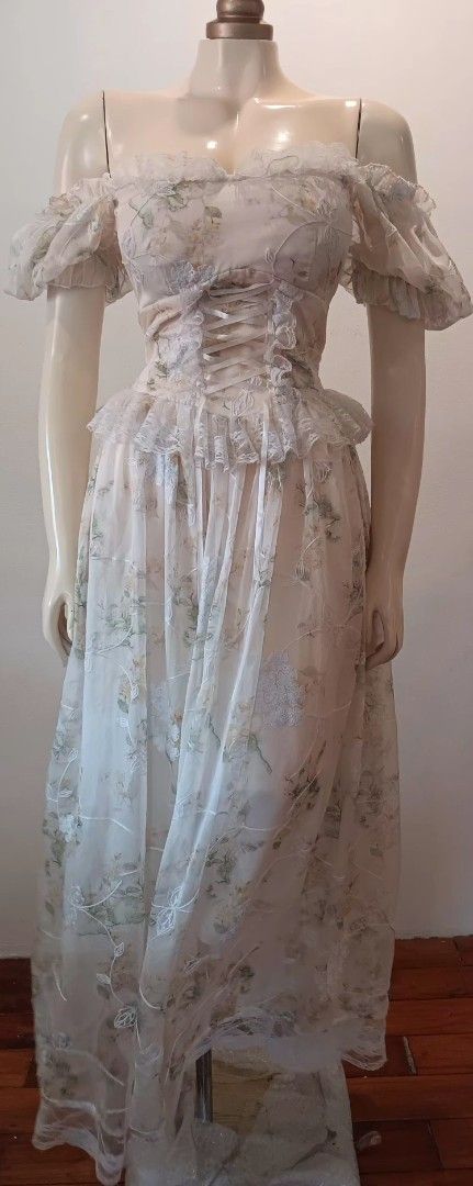 Fairy Core Floral Maxi Dress (Category: Dresses) located in Manila. Submitted by sonummy (Listing ID 1430915857, Image 2). Description: Elegant maxi dress featuring an off-shoulder design with delicate floral print. The dress has a fitted bodice with ruffled detailing and a flowing skirt. It has short, puffy sleeves and a shirred back for a comfortable fit. The dress is made of a lightweight, semi-sheer fabric, perfect for special occasions..