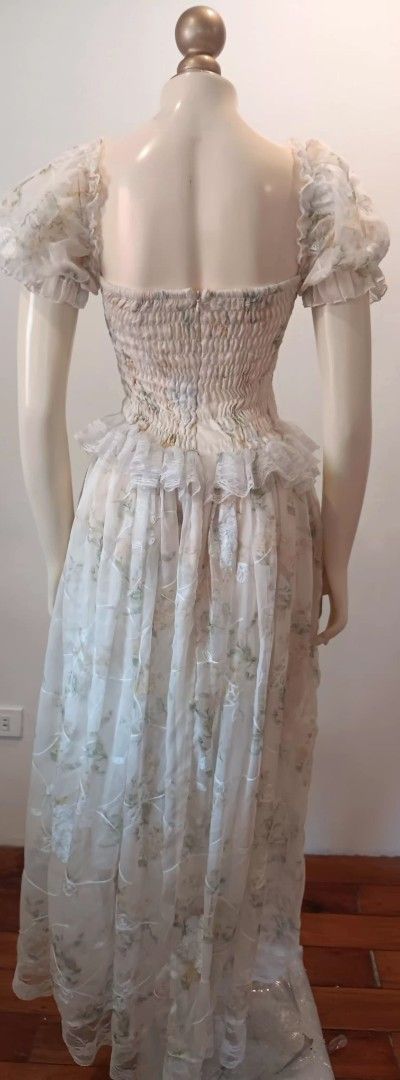 Fairy Core Floral Maxi Dress (Category: Dresses) located in Manila. Submitted by sonummy (Listing ID 1430915857, Image 3). Description: Elegant maxi dress featuring an off-shoulder design with delicate floral print. The dress has a fitted bodice with ruffled detailing and a flowing skirt. It has short, puffy sleeves and a shirred back for a comfortable fit. The dress is made of a lightweight, semi-sheer fabric, perfect for special occasions..