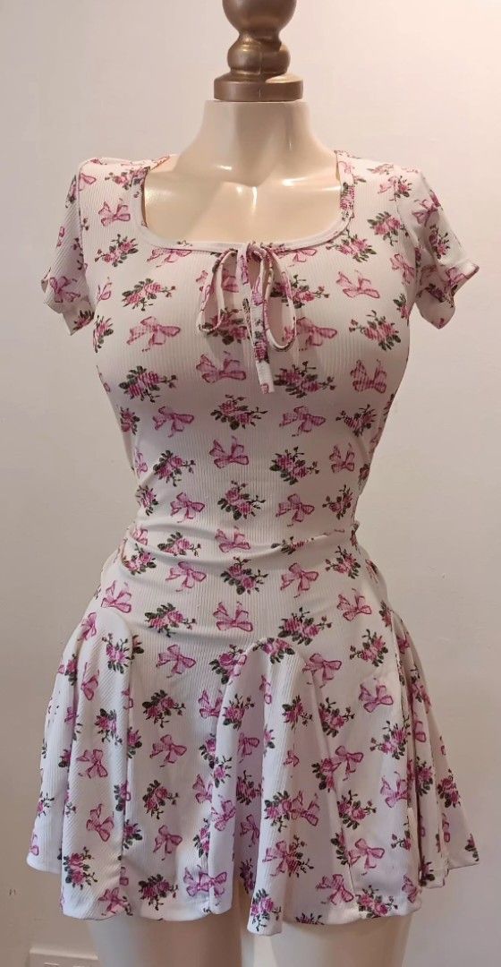 Floral Print Dress (Category: Dresses) located in Manila. Submitted by sonummy (Listing ID 1430915520, Image 2). Description: Dress features a delicate floral print with pink accents. It has a scoop neckline with a tie detail and short sleeves. The dress has a fitted bodice and a flared skirt..