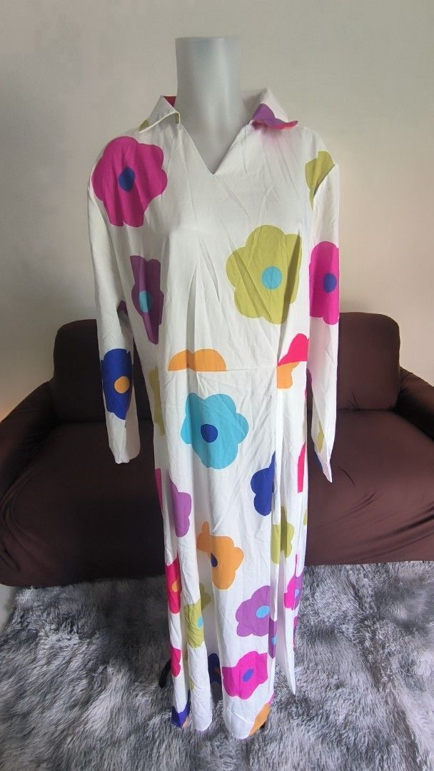 Floral Print Maxi Dress (Category: Dresses) located in Antipolo. Submitted by secondcharmstore (Listing ID 1430834977, Image 1). Description: sale 299 Maxi dress features a vibrant floral print on a white background. It has long sleeves and a collared neckline. The colorful floral pattern includes pink, blue, yellow, orange, and purple flowers. It's a stylish and eye-catching piece. no tag, never worn chest: 40-42 inches waist: 36-38 inches lengt