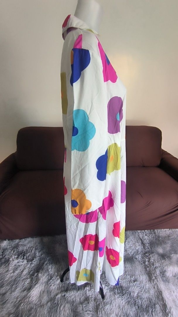 Floral Print Maxi Dress (Category: Dresses) located in Antipolo. Submitted by secondcharmstore (Listing ID 1430834977, Image 2). Description: sale 299 Maxi dress features a vibrant floral print on a white background. It has long sleeves and a collared neckline. The colorful floral pattern includes pink, blue, yellow, orange, and purple flowers. It's a stylish and eye-catching piece. no tag, never worn chest: 40-42 inches waist: 36-38 inches lengt