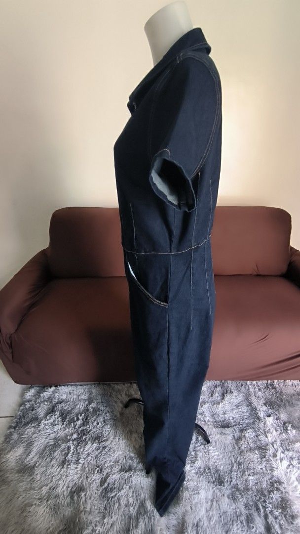 Forever 21+ Dark Denim Jumpsuit 1X (Category: Jumpsuits) located in Antipolo. Submitted by secondcharmstore (Listing ID 1430884705, Image 3). Description: sale 549 Forever 21+ dark denim jumpsuit. Features a collared neckline, short sleeves, and a full-length zipper. It has front pockets and decorative stitching details. The size is 1X. The original price tag is still attached. Made in China. chest: 42-44 inches waist: 36-40 inches length: 62 inc