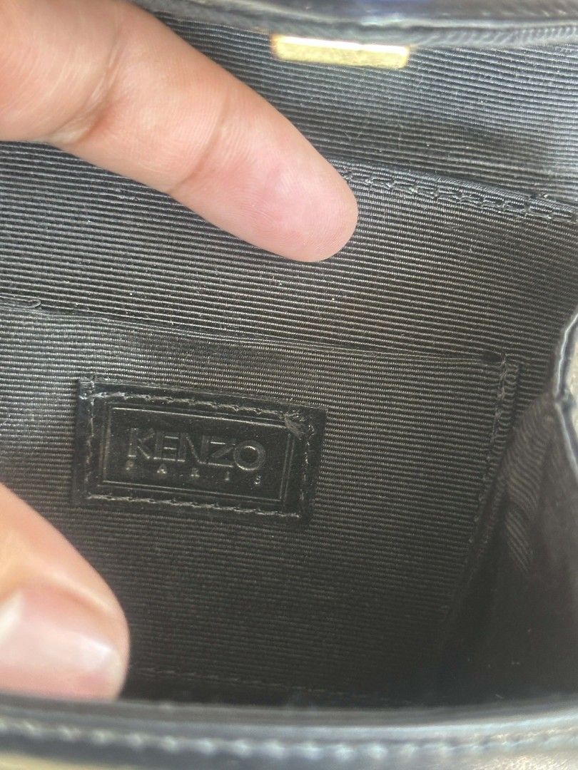 Kenzo Paris Embroidered Handbag (Category: Luxury Bags & Wallets) located in Caloocan City. Submitted by thon0806 (Listing ID 1430808862, Image 3). Description: Elegant black handbag from Kenzo Paris. Features a unique embroidered floral design on the flap and a blue handle. The bag has a button closure and a structured shape. The interior is lined with fabric and includes a Kenzo Paris label. A stylish accessory for any occasion..