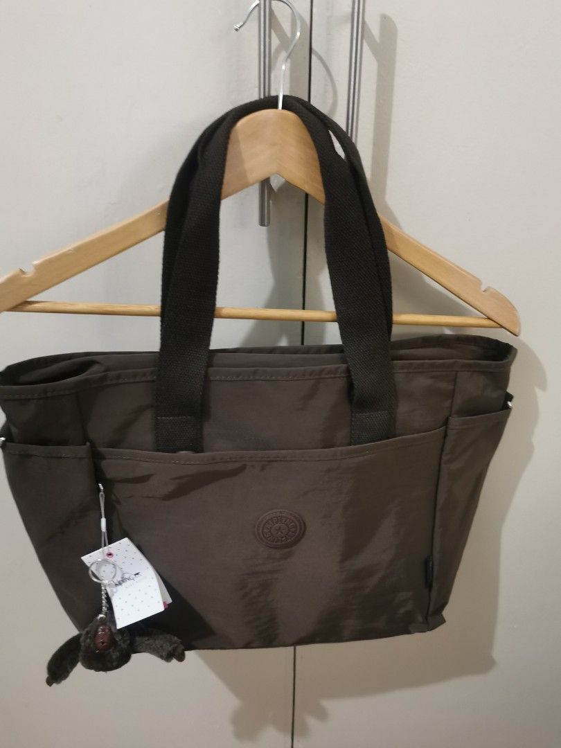 Kipling dark brown large bag (Category: Shoulder Bags) located in Quezon City. Submitted by declutter68112 (Listing ID 1430843289, Image 1). Description: Dark brown Kipling large shoulder bag with straps and many compartments..