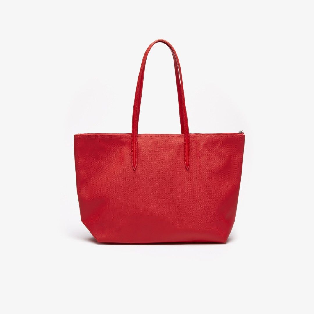 Lacoste Red Tote Bag (Category: Tote Bags) located in Manila. Submitted by sonummy (Listing ID 1430956998, Image 2). Description: - Lacoste tote bag in vibrant red. - Features a clean, minimalist design. - Secure top zipper closure. - Comfortable shoulder straps. - Includes the iconic Lacoste logo. - Made of a smooth material..