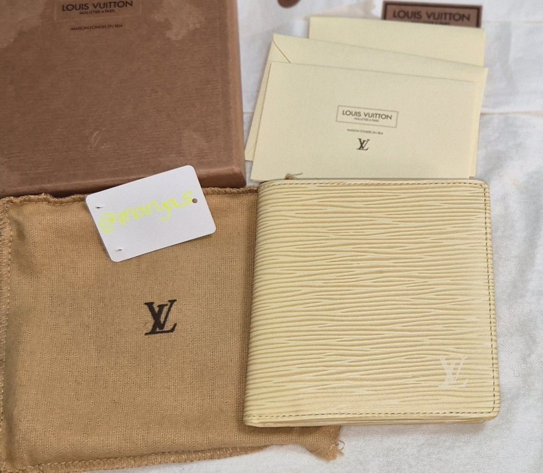 Louis Vuitton Epi Leather Wallet (Category: Luxury Bags & Wallets) located in Quezon City. Submitted by marya_s (Listing ID 1430872743, Image 1). Description: Authentic Louis Vuitton Epi Leather wallet. Features multiple card slots and a coin compartment. The wallet has a textured exterior and a smooth leather interior. Includes original box and tags. The color is a light yellow or cream. The Louis Vuitton logo is subtly embossed on the front and