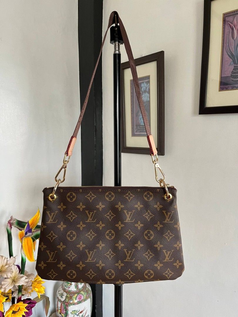 Louis Vuitton Eva Clutch (Category: Luxury Bags & Wallets) located in Baguio. Submitted by 28th_thrift_alley (Listing ID 1430842833, Image 2). Description: Authentic Louis Vuitton Pochette Felicie in brown. Features the iconic LV monogram pattern. Includes a gold-tone chain strap. The interior is lined with a red fabric. The bag has a gold-tone zipper closure. Made in France..