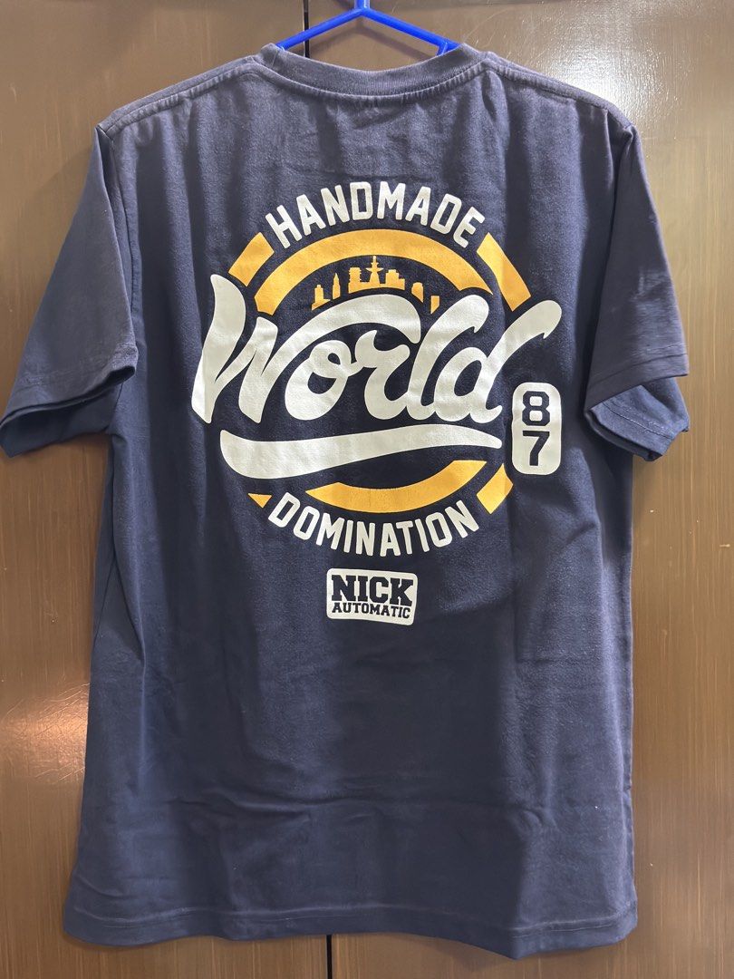 Nick Automatic World Domination T-shirt (Category: Tshirts & Polo Shirts ) located in Bacoor. Submitted by brianluistro (Listing ID 1430871714, Image 2). Description: - Navy blue Nick Automatic T-shirt - Features "World Domination" graphic (front and back) - Short sleeves, crew neck - Size: Small - Made in the Philippines.