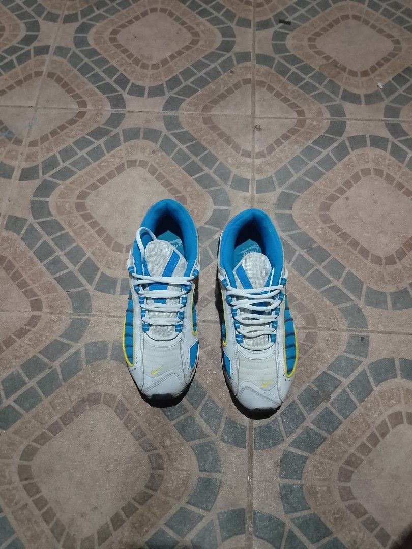 Nike Air Max Tailwind IV - White Blue (Category: Sneakers) located in Caloocan City. Submitted by y2kgearrr (Listing ID 1430912860, Image 3). Description: Nike Air Max Tailwind IV sneakers in white and blue. Features a blue interior and white laces. The size is US 8. The shoes have a visible Air Max unit in the heel. The design includes yellow accents. The shoes have the Nike logo on the side and the Max Air logo on the back..