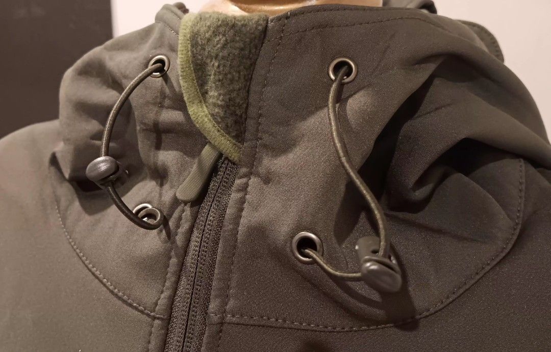 Olive Green Tactical Softshell Jacket (Category: Coats, Jackets and Outerwear) located in Manila. Submitted by sonummy (Listing ID 1430911407, Image 2). Description: Olive green tactical softshell jacket with a hood. Features multiple pockets, adjustable cuffs, and a full-length zipper. The hood has drawstrings for adjustment. Includes adjustable sleeve cuffs with velcro straps..