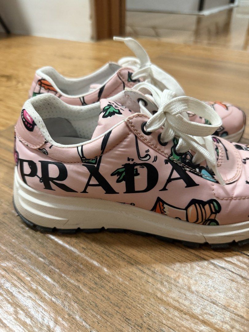 Prada Printed Sneakers - Size 37.5 (Category: Sneakers & Footwear) located in Bacoor. Submitted by da.clutter (Listing ID 1430907973, Image 2). Description: - Authentic Prada sneakers - Size 37.5 - Playful pink design with cartoon figures - White laces and soles - "PRADA" printed on the side - Prada logo on insole - Made in Italy.
