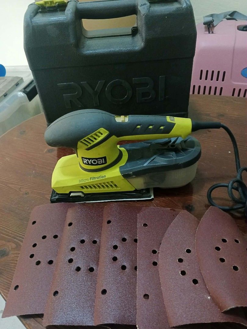 Ryobi Orbital Sander with Case (Category: Construction Tools & Equipment) located in Caloocan City. Submitted by youngdog_7a3ee7 (Listing ID 1430879906, Image 3). Description: Ryobi orbital sander with a case and sanding pads. The sander is yellow and black. It has a dust collection system. The case is black with the Ryobi logo. Includes several sanding pads. The power cord is included..