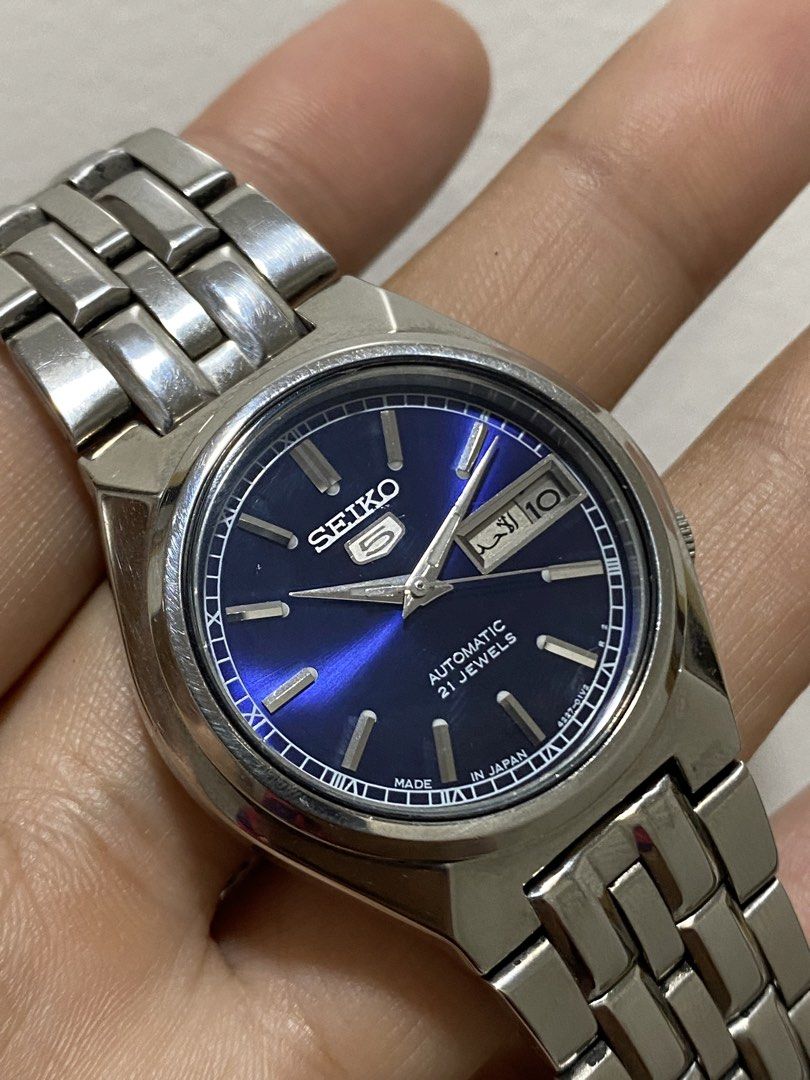 Seiko 5 Automatic "Blue Sunburst" (JDM) (Category: Luxury Watches) located in Baliuag. Submitted by watchmechanic (Listing ID 1430928084, Image 1). Description: Seiko 5 Automatic "Blue Sunburst" (JDM) Price: ₱ Condition: Good running condition Quick Specs: Movement: 21-Jewel Automatic Dial: Stunning Deep Blue Sunburst Features: Day/Date window (English/Arabic) Build: All Stainless Steel, "Made in Japan" model Details: Authentic and original. Keep