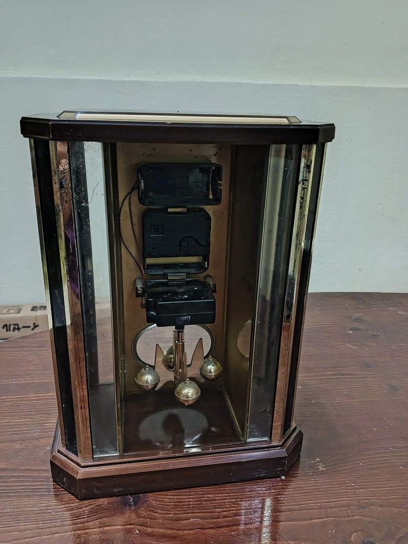 Seiko Quartz Pendulum Clock (Category: Clocks) located in Caloocan City. Submitted by youngdog_7a3ee7 (Listing ID 1430887097, Image 3). Description: Vintage Seiko quartz pendulum clock. Features a rectangular wooden frame with glass panels. The clock face displays Roman numerals and the Seiko logo. The pendulum is visible at the bottom. Requires batteries to operate. A classic piece for any home..