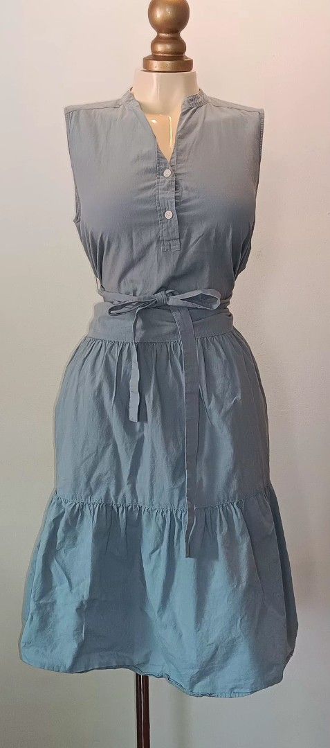 Sleeveless Tiered Dress (Category: Dresses) located in Manila. Submitted by sonummy (Listing ID 1430912738, Image 1). Description: Sleeveless dress features a mandarin collar and a tiered skirt. It includes a matching belt to cinch the waist. The dress has a button-down front and a midi length. It is a solid color, suitable for casual wear..
