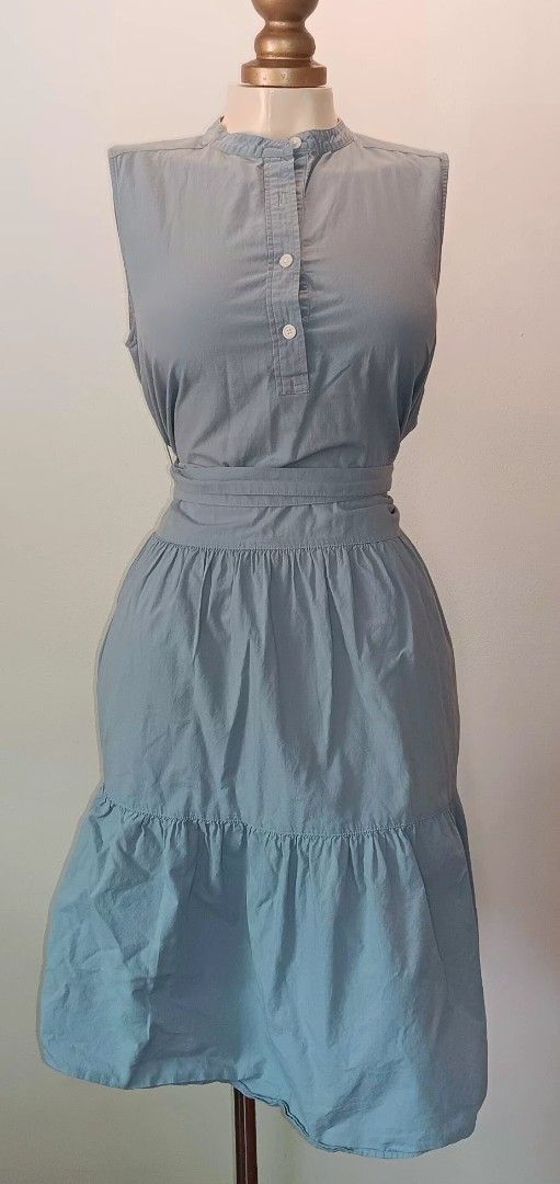 Sleeveless Tiered Dress (Category: Dresses) located in Manila. Submitted by sonummy (Listing ID 1430912738, Image 2). Description: Sleeveless dress features a mandarin collar and a tiered skirt. It includes a matching belt to cinch the waist. The dress has a button-down front and a midi length. It is a solid color, suitable for casual wear..
