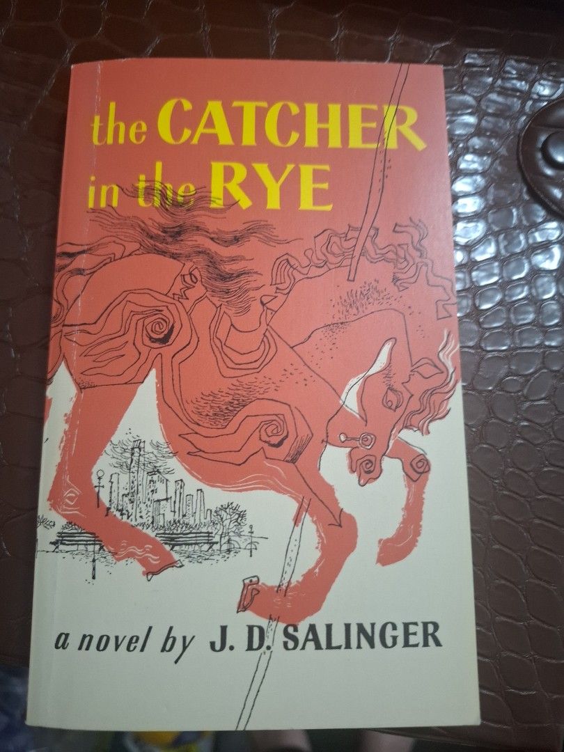 The Catcher in the Rye by J.D. Salinger (Category: Storybooks) located in Paranaque City. Submitted by dorothyperalta (Listing ID 1430931949, Image 1). Description: - "The Catcher in the Rye" by J.D. Salinger - Features an orange cover - Includes a drawing of a horse - Title printed in yellow - A novel.