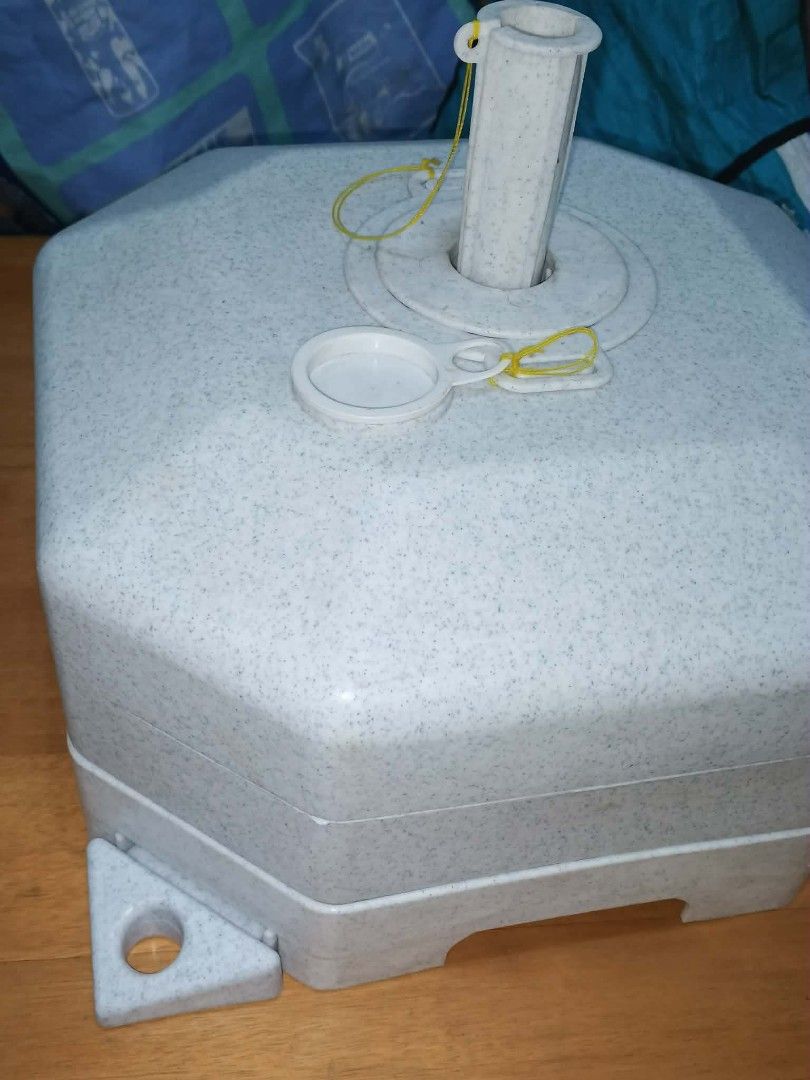 Umbrella Base with Pole Holder (Category: Umbrellas) located in Caloocan City. Submitted by youngdog_7a3ee7 (Listing ID 1430885233, Image 3). Description: Durable umbrella base with a unique octagonal design. Includes a pole holder and a cap. Features a light gray speckled finish. The base has several mounting points. Perfect for securing your outdoor umbrella..