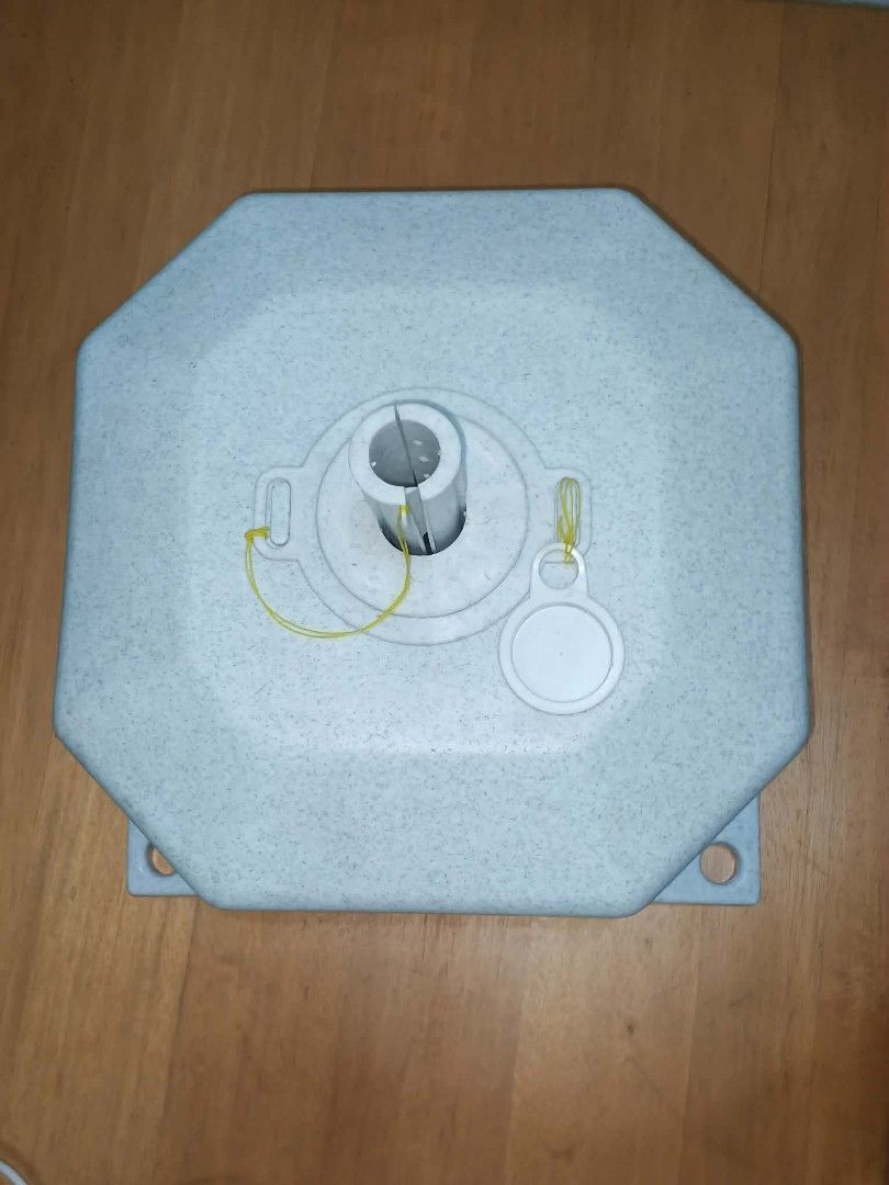 Umbrella Base with Pole Holder (Category: Umbrellas) located in Caloocan City. Submitted by youngdog_7a3ee7 (Listing ID 1430885233, Image 1). Description: Durable umbrella base with a unique octagonal design. Includes a pole holder and a cap. Features a light gray speckled finish. The base has several mounting points. Perfect for securing your outdoor umbrella..