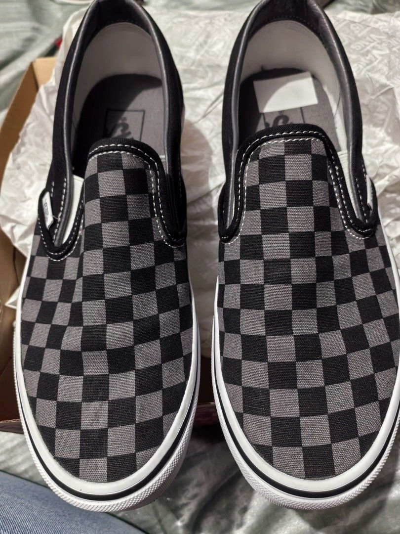 Vans Checkerboard Slip-On Sneakers (Category: Sneakers) located in Valenzuela. Submitted by jayejo (Listing ID 1430969604, Image 2). Description: Classic Vans slip-on sneakers in a black and gray checkerboard pattern. Features the Vans logo on the side and insole. The shoes are in their original box. The soles are white with a black stripe. The insole is gray with the Vans logo..