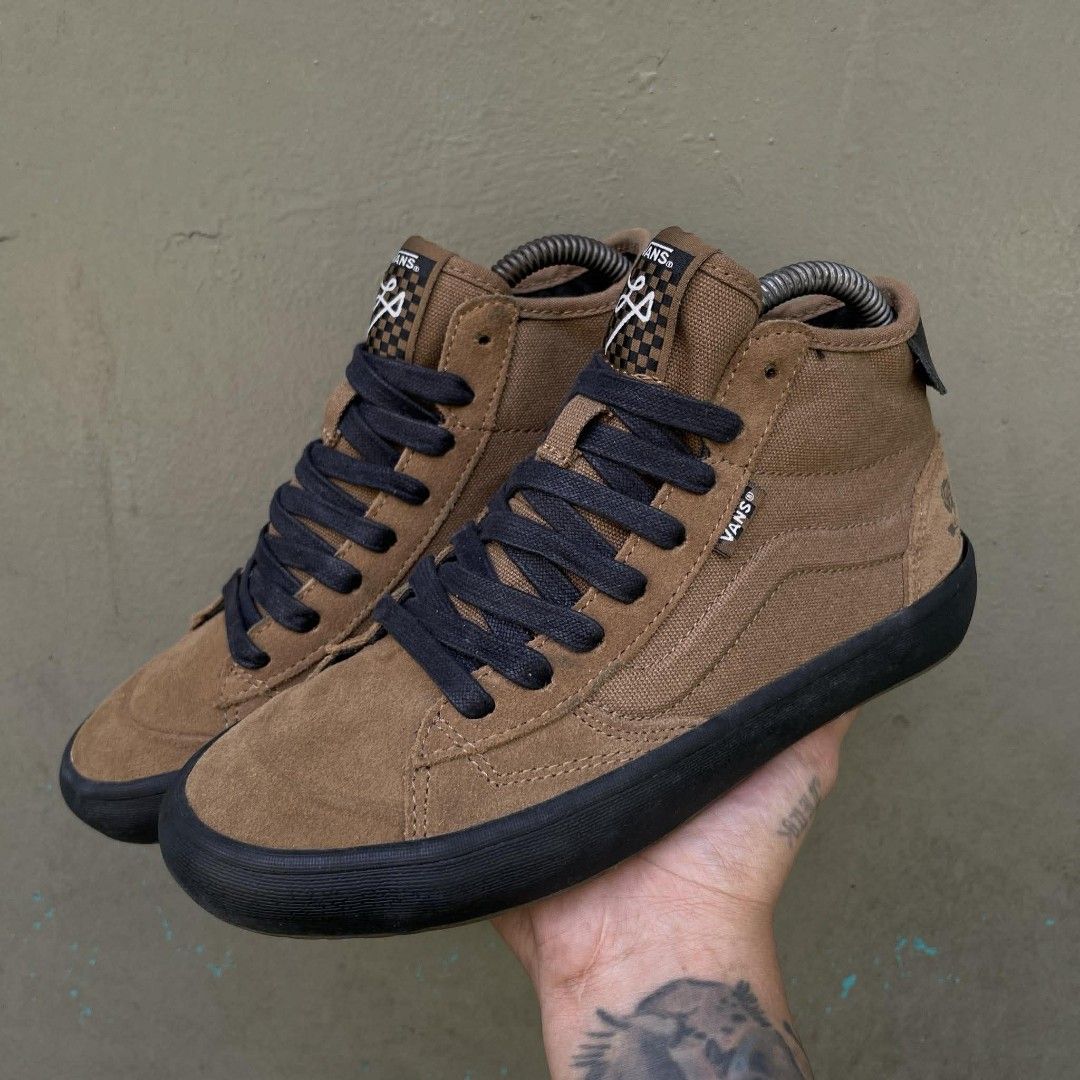 Vans Sk8-Mid Pro Skate Shoes (Category: Sneakers) located in Quezon City. Submitted by ibenta.ph (Listing ID 1430965030, Image 1). Description: Brown Vans Sk8-Mid Pro skate shoes with black soles and laces. Features the Vans logo on the side and "Off The Wall" branding on the heel. The shoes have a high-top design with a combination of suede and canvas materials. The tongue has a checkered pattern and a logo. Size 6.5 womens Excellent condition .