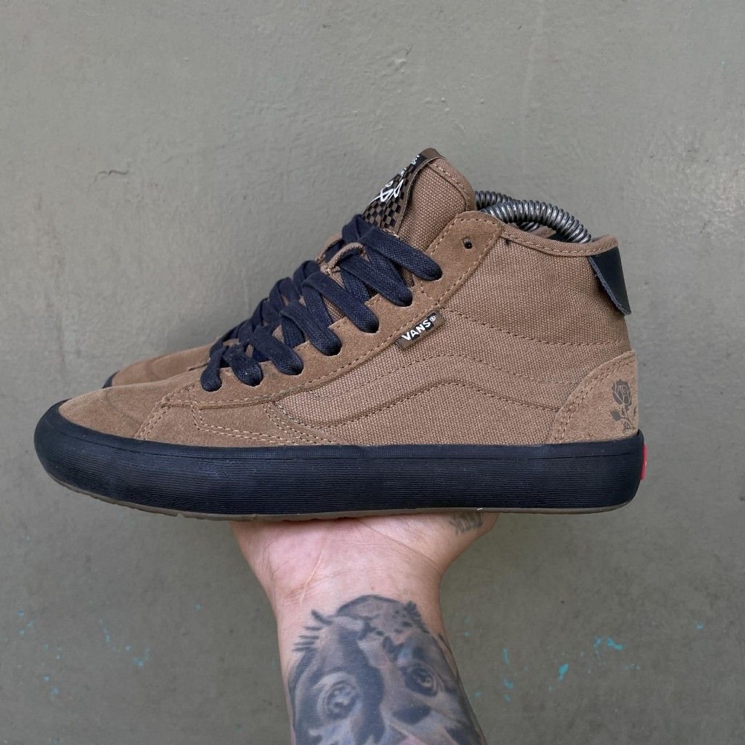 Vans Sk8-Mid Pro Skate Shoes (Category: Sneakers) located in Quezon City. Submitted by ibenta.ph (Listing ID 1430965030, Image 2). Description: Brown Vans Sk8-Mid Pro skate shoes with black soles and laces. Features the Vans logo on the side and "Off The Wall" branding on the heel. The shoes have a high-top design with a combination of suede and canvas materials. The tongue has a checkered pattern and a logo. Size 6.5 womens Excellent condition .