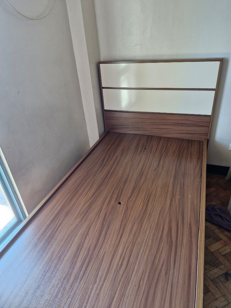 Wooden Bed Frame with Storage (Category: Bed Frames & Mattresses) located in Mandaluyong City. Submitted by _fabfinds (Listing ID 1430860654, Image 1). Description: Mandaue Foam wooden bed frame with a headboard and built-in storage drawers. The frame has a brown wood finish with white accents on the headboard. The bed frame is designed with a modern aesthetic, offering both style and functionality for a bedroom. Lightly used, in very good condit