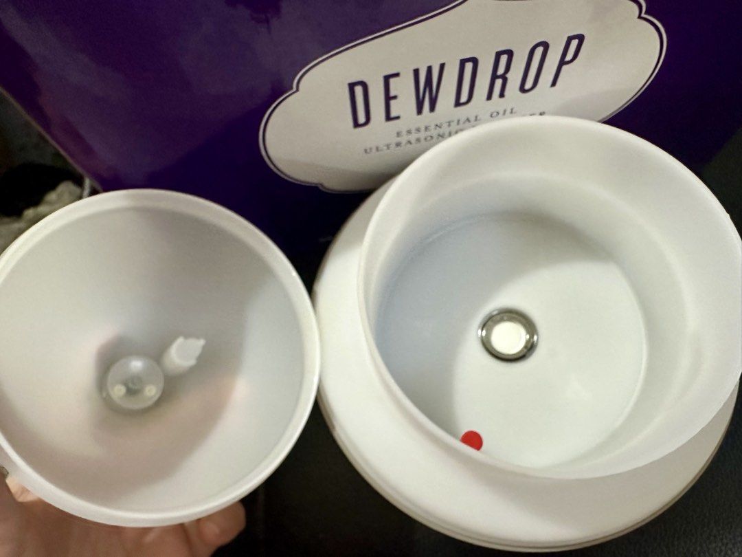 Young Living Dewdrop Essential Oil Diffuser (Category: Home Fragrance) located in San Pedro. Submitted by mysticdog_8deb08 (Listing ID 1430848657, Image 2). Description: Young Living Dewdrop Essential Oil Ultrasonic Diffuser. It comes with the original box and three essential oils: Lemon, PanAway, and Lavender. The diffuser has a teardrop shape with a white and gray color scheme. The internal components are also visible in the images. Note: the d