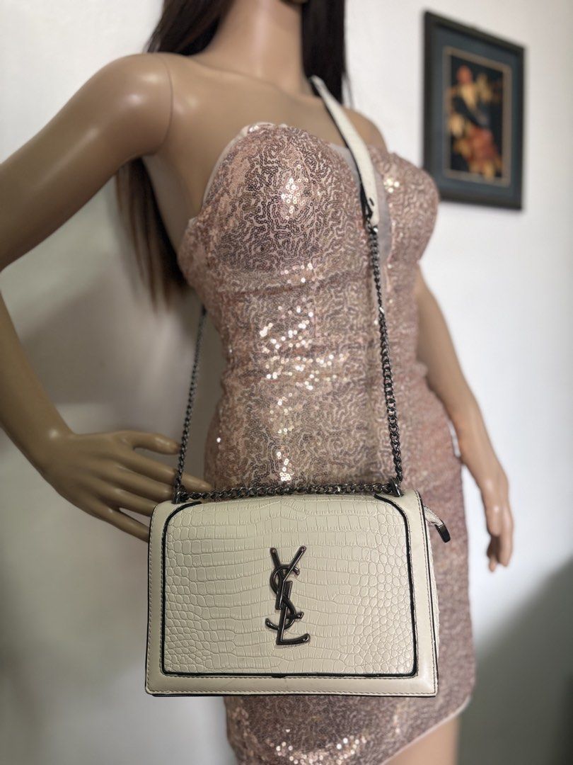 YSL Croc-Embossed Shoulder Bag no code (Category: Luxury Bags & Wallets) located in Davao. Submitted by emmanuelchuamellorin23 (Listing ID 1428814566, Image 3). Description: Not coded pero makapal mabigat Elegant shoulder bag featuring a croc-embossed design. It has a chain strap and a flap closure. The bag showcases the YSL logo on the front. The color is off-white with black trim. The strap is a combination of leather and chain..