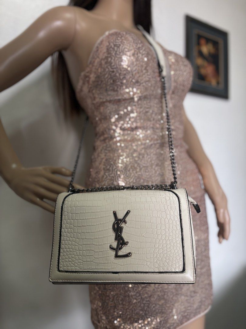 YSL Croc-Embossed Shoulder Bag no code (Category: Luxury Bags & Wallets) located in Davao. Submitted by emmanuelchuamellorin23 (Listing ID 1428814566, Image 1). Description: Not coded pero makapal mabigat Elegant shoulder bag featuring a croc-embossed design. It has a chain strap and a flap closure. The bag showcases the YSL logo on the front. The color is off-white with black trim. The strap is a combination of leather and chain..